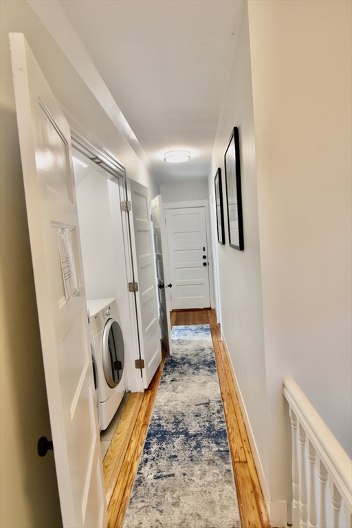 14 Castlerock Street, Unit 14 Boston, MA 02125 - Photo 27 of 32 a hallway with washer and dryer
