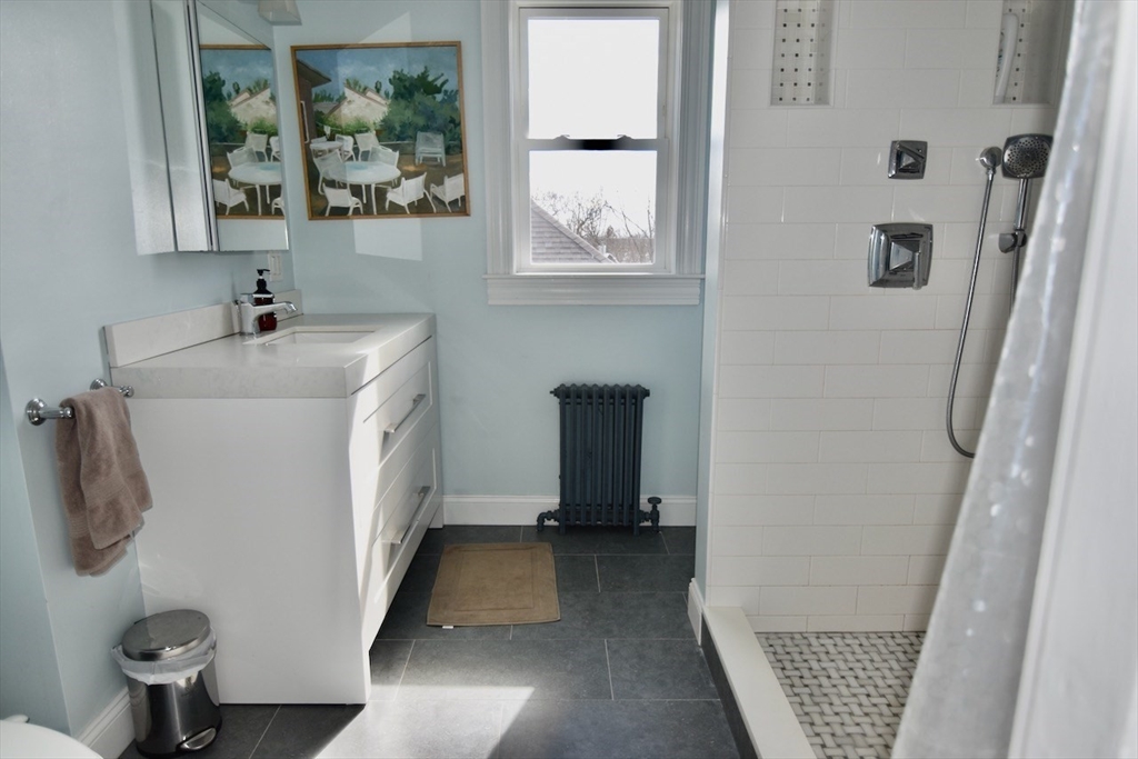 14 Castlerock Street, Unit 14 Boston, MA 02125 - Photo 30 of 32 a bathroom with a sink and a mirror