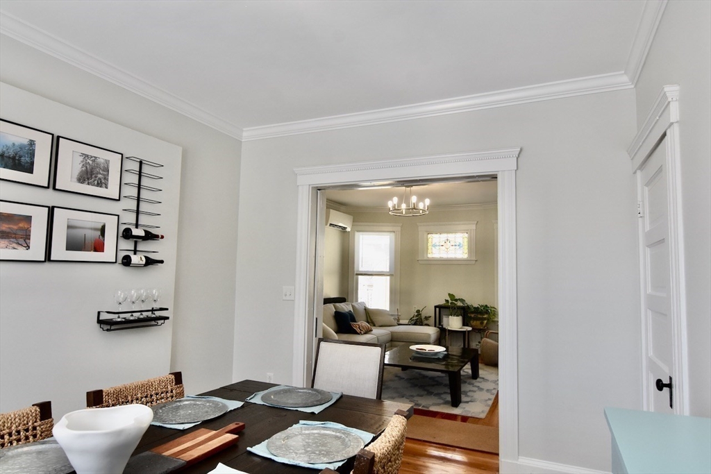 14 Castlerock Street, Unit 14 Boston, MA 02125 - Photo 9 of 32 a living room with furniture and a book shelf