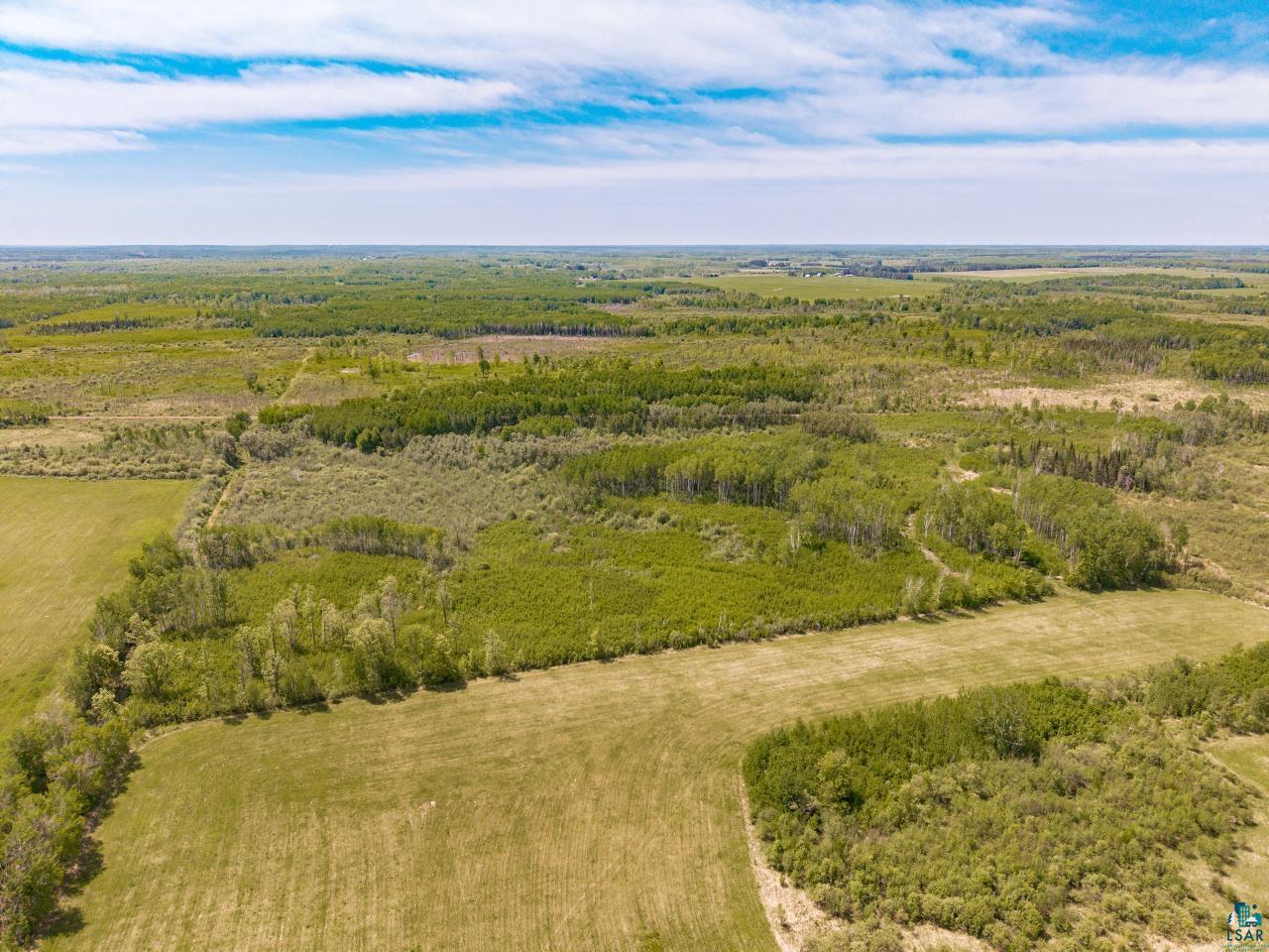6606 Metso Road Kettle River, MN 55757 - Photo 45 of 84 Expansive agricultural land featuring a mix of open fields and natural tree lines