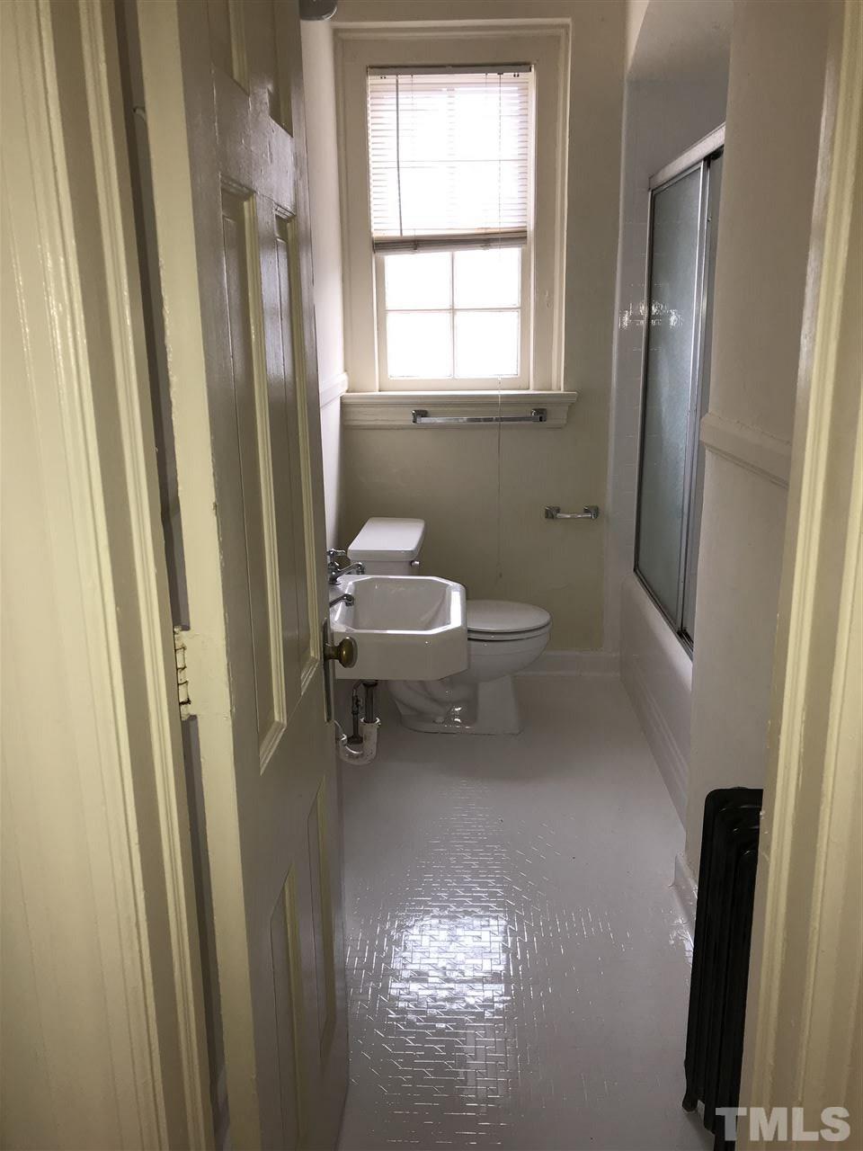2402 Clark Avenue, Unit 10 Raleigh, NC 27607 - Photo 7 of 19 a bathroom with a toilet and a shower curtain