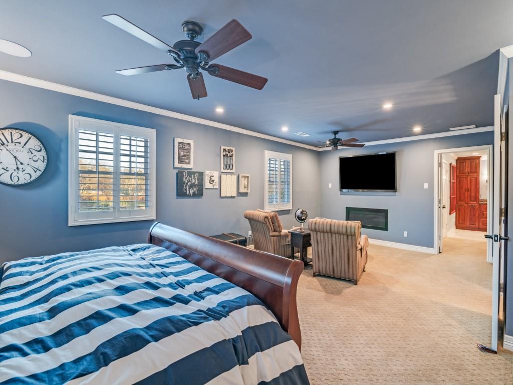 343 East Tripp Road Sunnyvale, TX 75182 - Photo 17 of 36 a bedroom with a bed and a flat screen tv