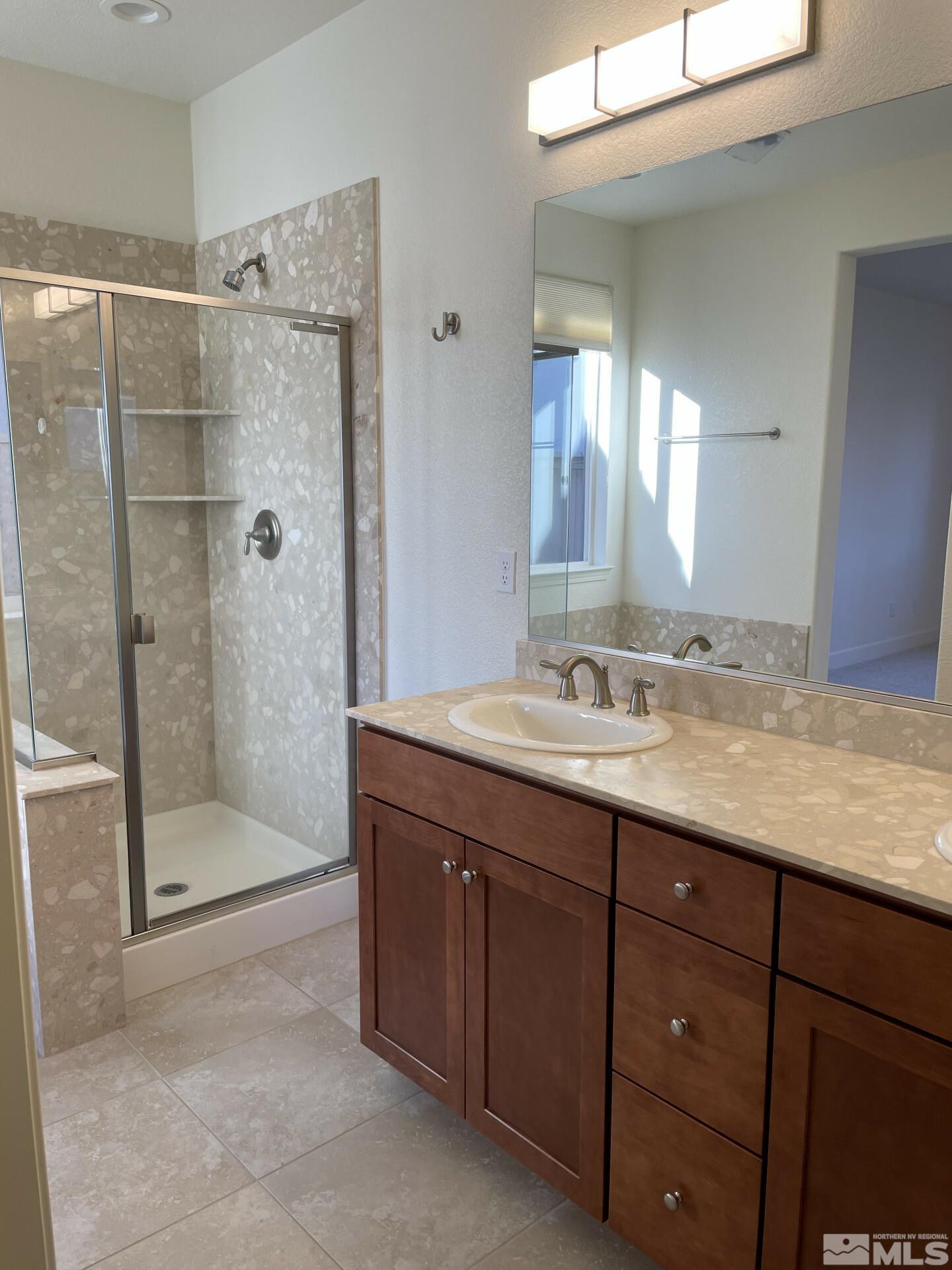 2087 Whitecliff Drive Reno, NV 89521 - Photo 15 of 33 a bathroom with a granite countertop sink mirror and shower