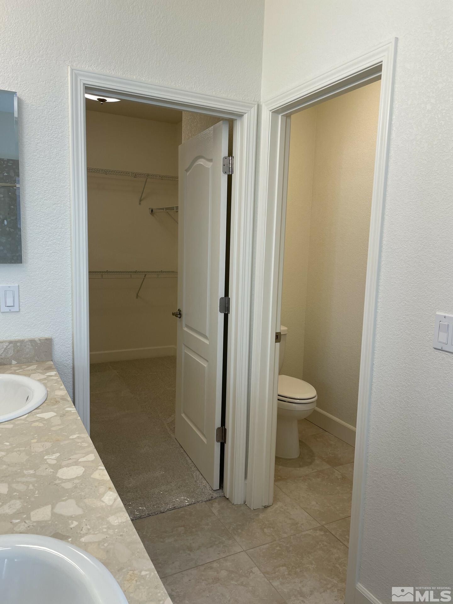 2087 Whitecliff Drive Reno, NV 89521 - Photo 19 of 33 a bathroom with a granite countertop toilet and a shower