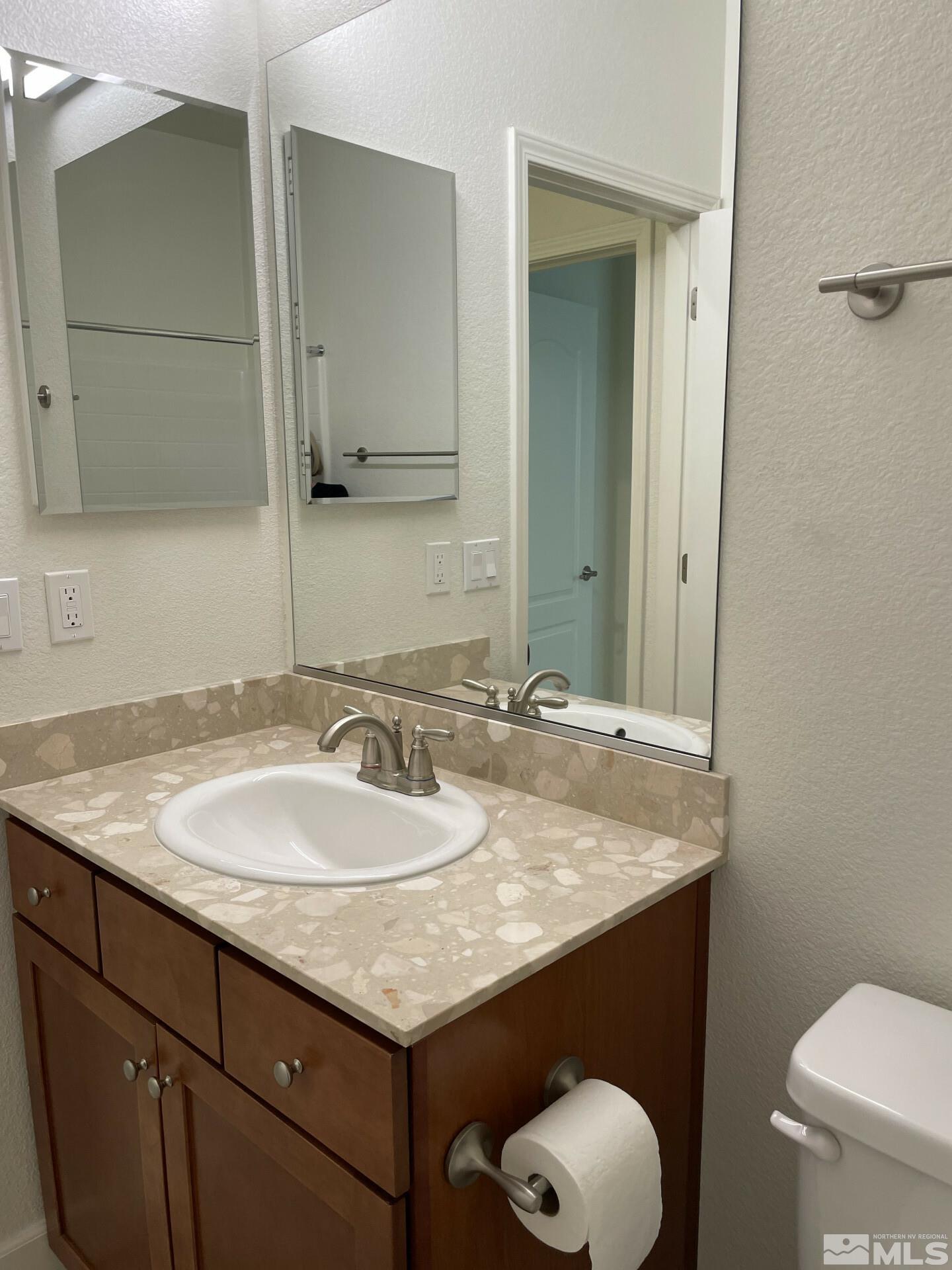 2087 Whitecliff Drive Reno, NV 89521 - Photo 20 of 33 a bathroom with a granite countertop sink and a mirror