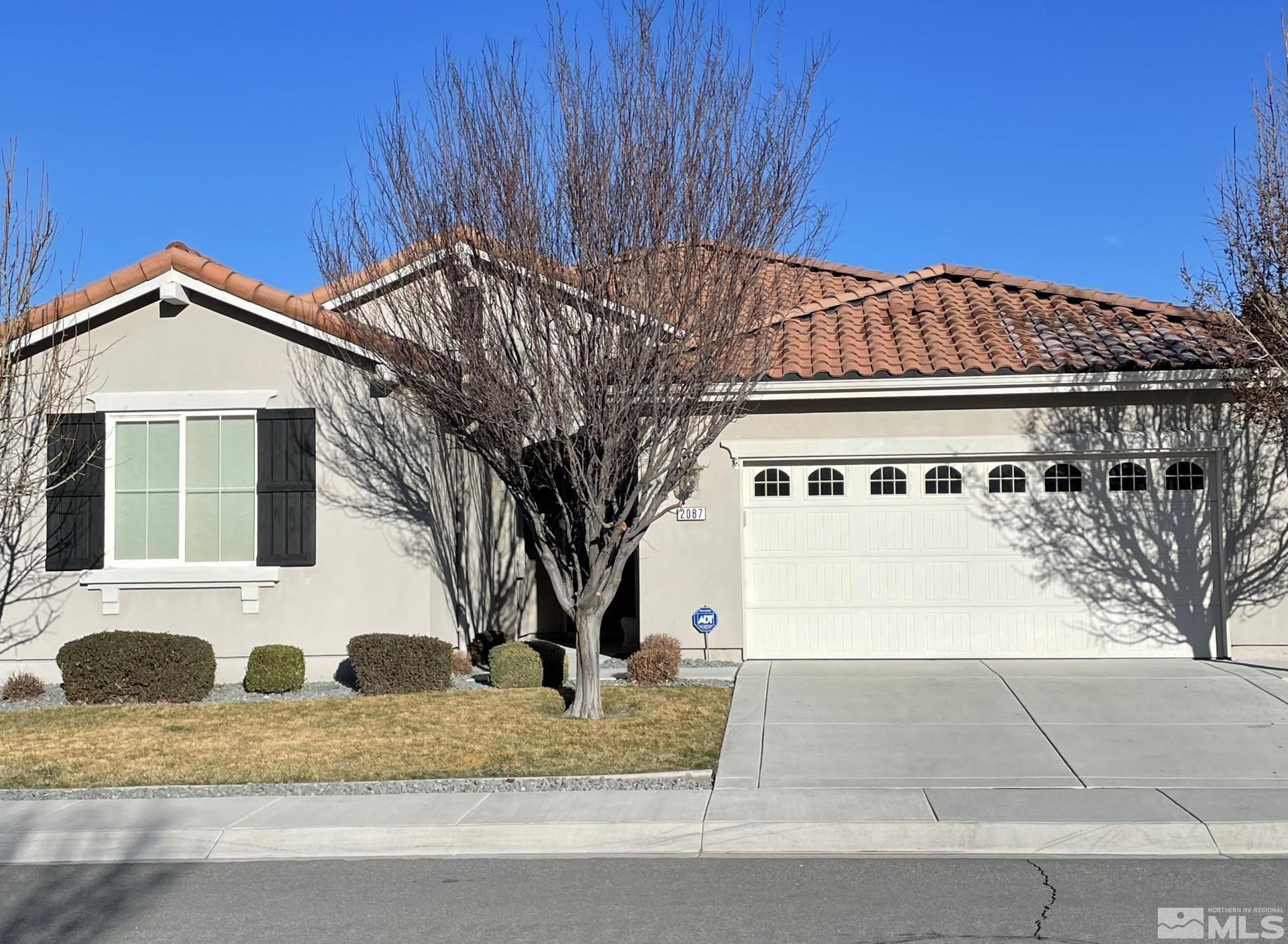 2087 Whitecliff Drive Reno, NV 89521 - Photo 2 of 33 a front view of a house with a yard and garage