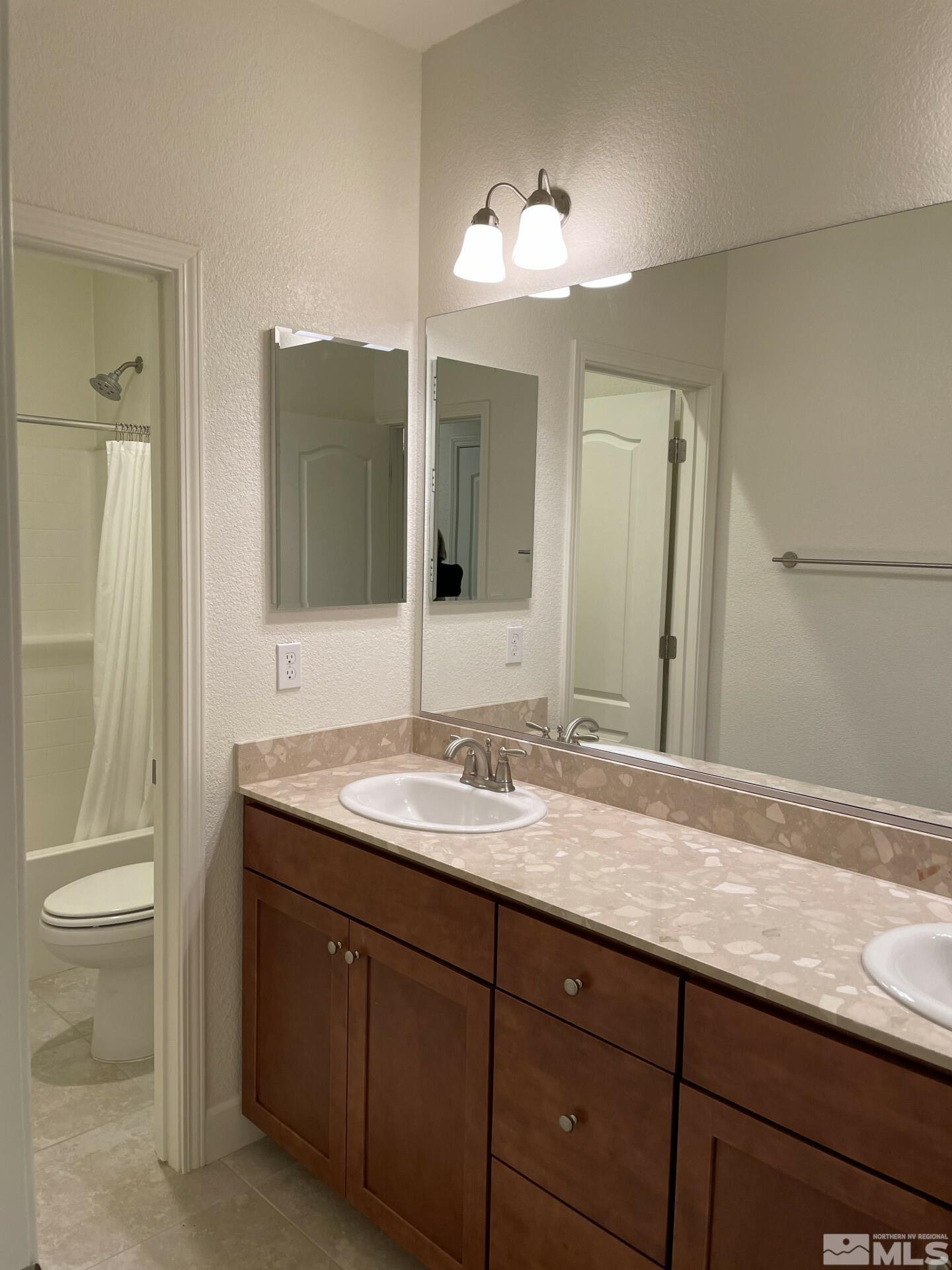 2087 Whitecliff Drive Reno, NV 89521 - Photo 23 of 33 a bathroom with a sink and a mirror