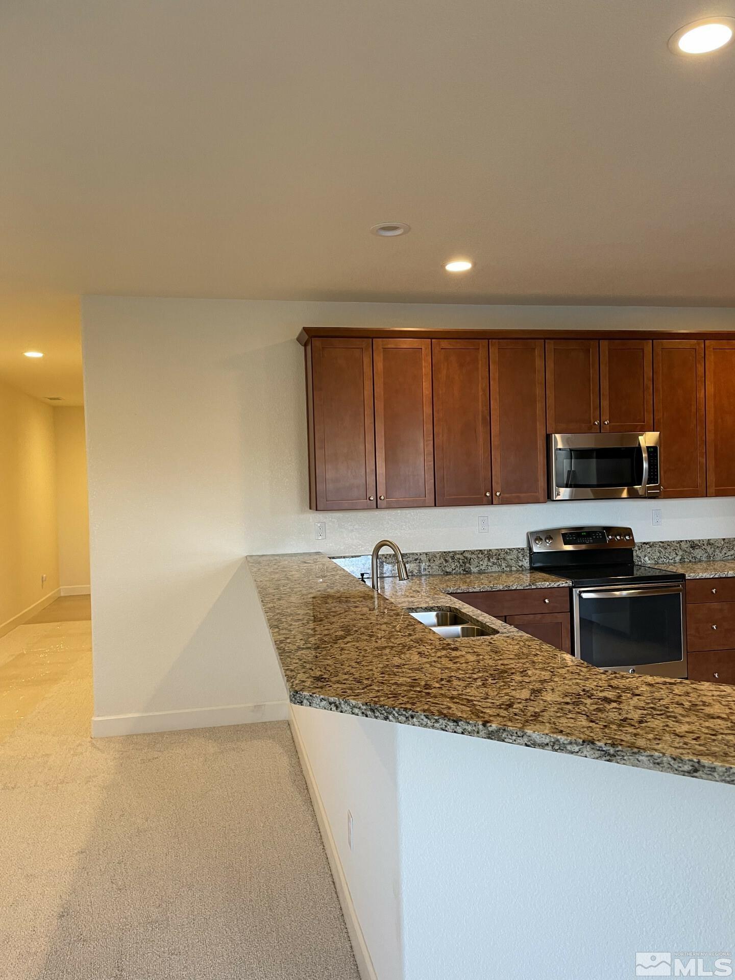 2087 Whitecliff Drive Reno, NV 89521 - Photo 8 of 33 a kitchen with stainless steel appliances granite countertop a sink a stove counter space and cabinets