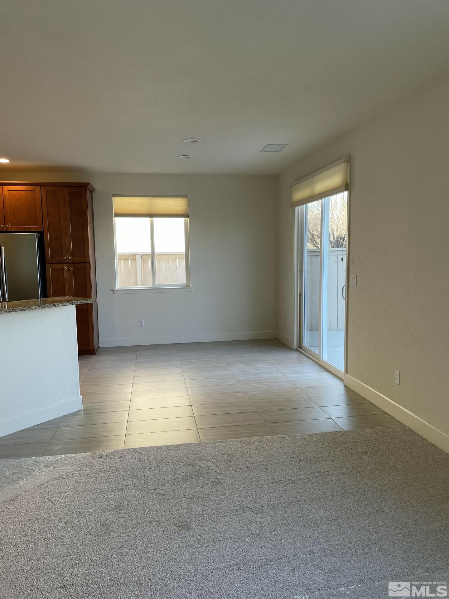 2087 Whitecliff Drive Reno, NV 89521 - Photo 9 of 33 an empty room with a fireplace and windows