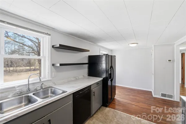 a kitchen with stainless steel appliances granite countertop a refrigerator and a sink