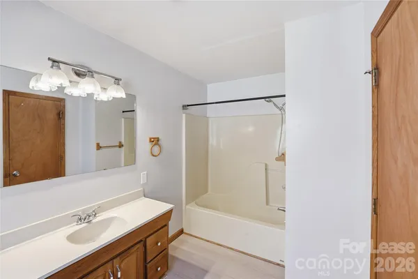 a bathroom with a bathtub a sink and a mirror