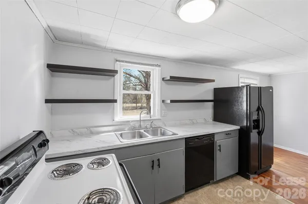 a kitchen with a sink a stove and refrigerator