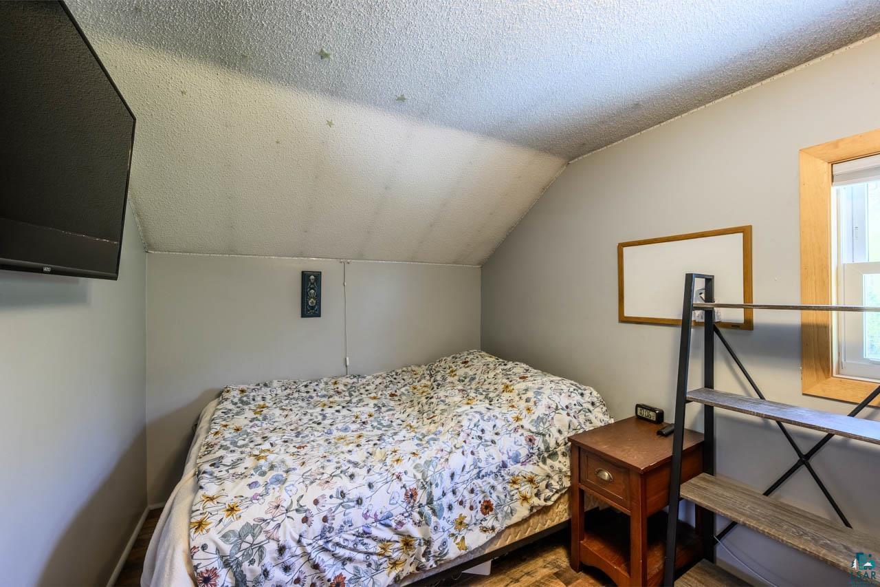 2581 O'Rourke Road Hibbing, MN 55746 - Photo 22 of 61 Sloped ceiling room featuring light gray walls and wood-finish flooring