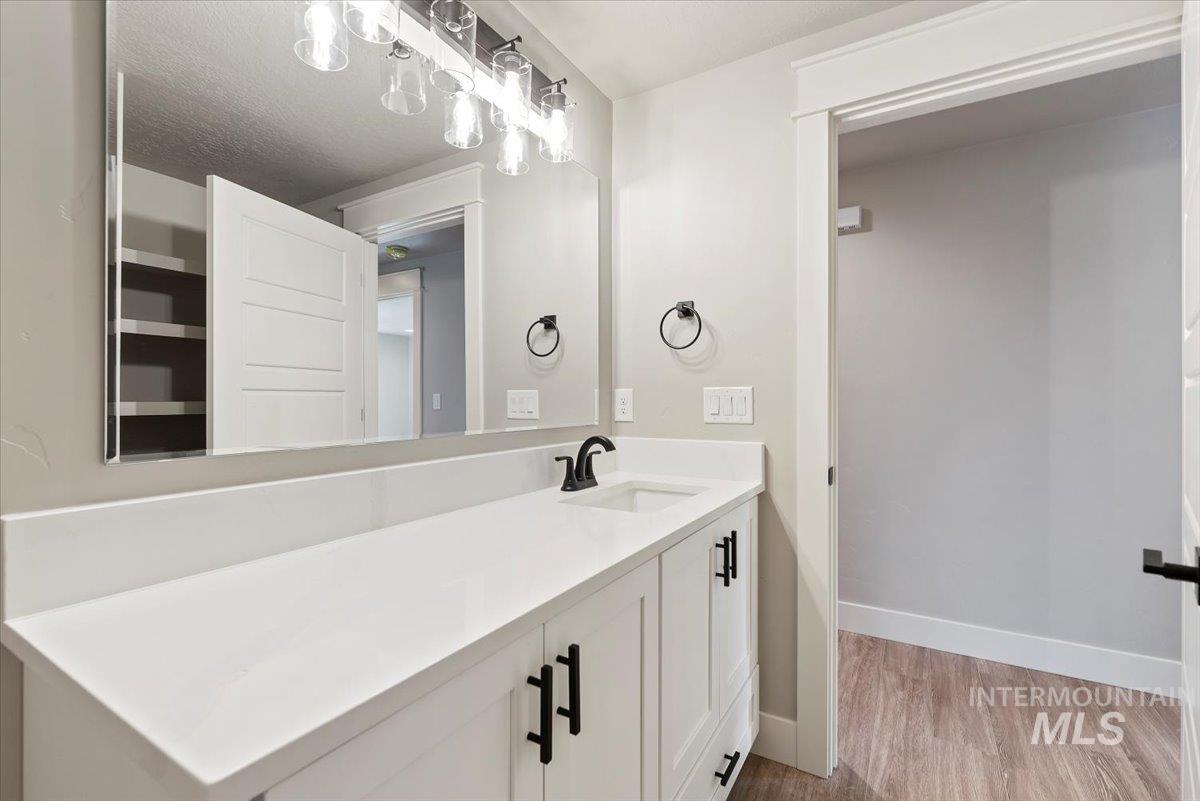 2435 North Black Cat Road Meridian, ID 83646 - Photo 25 of 32 Bathroom featuring vanity and light wood-style floors