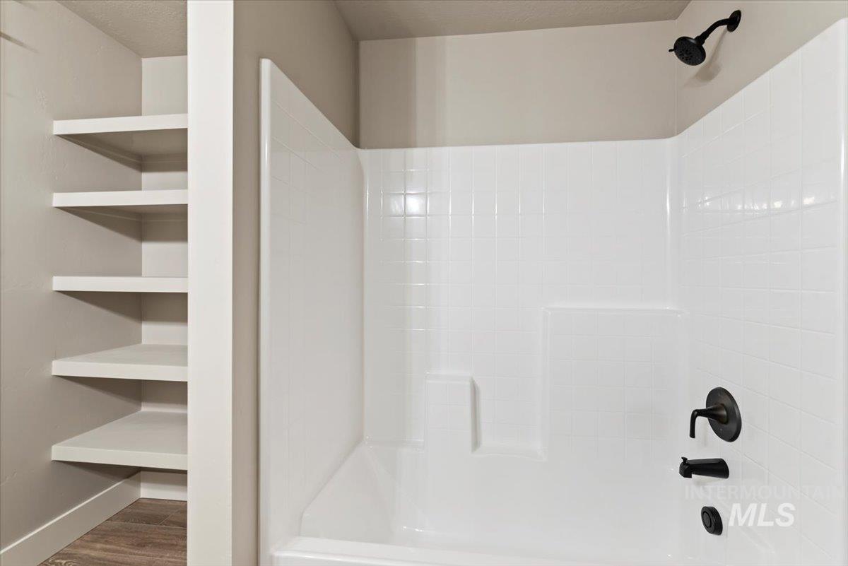 2435 North Black Cat Road Meridian, ID 83646 - Photo 26 of 32 Full bathroom featuring bathing tub / shower combination and wood finished floors