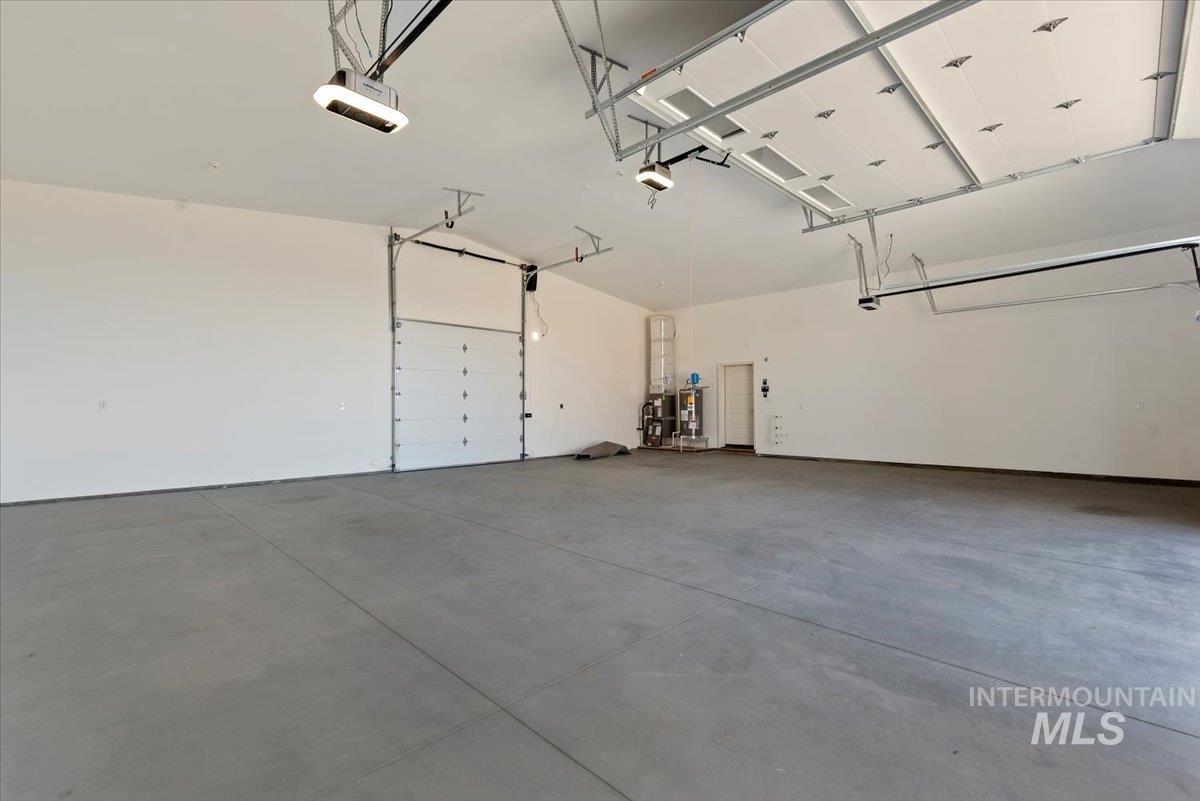 2435 North Black Cat Road Meridian, ID 83646 - Photo 30 of 32 Garage with water heater and a garage door opener