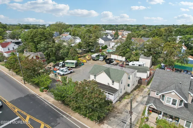 an aerial view of residential building with green space