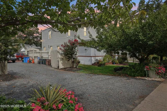 a front view of house with a garden