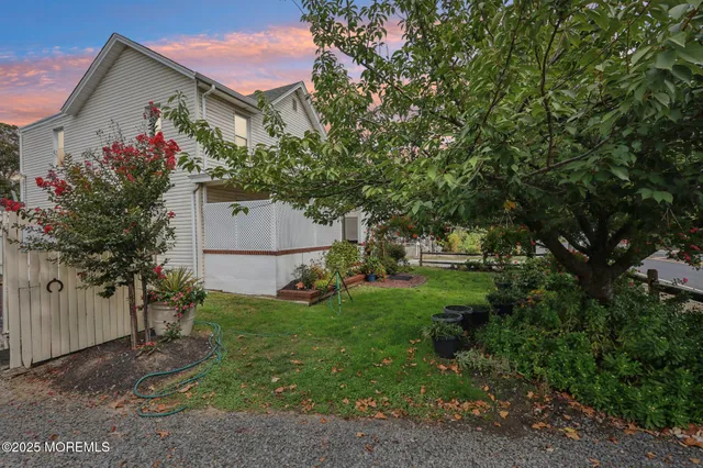 a front view of a house with a yard and outdoor seating