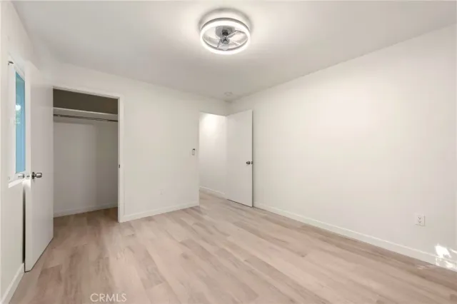 a view of room with hardwood floor and window