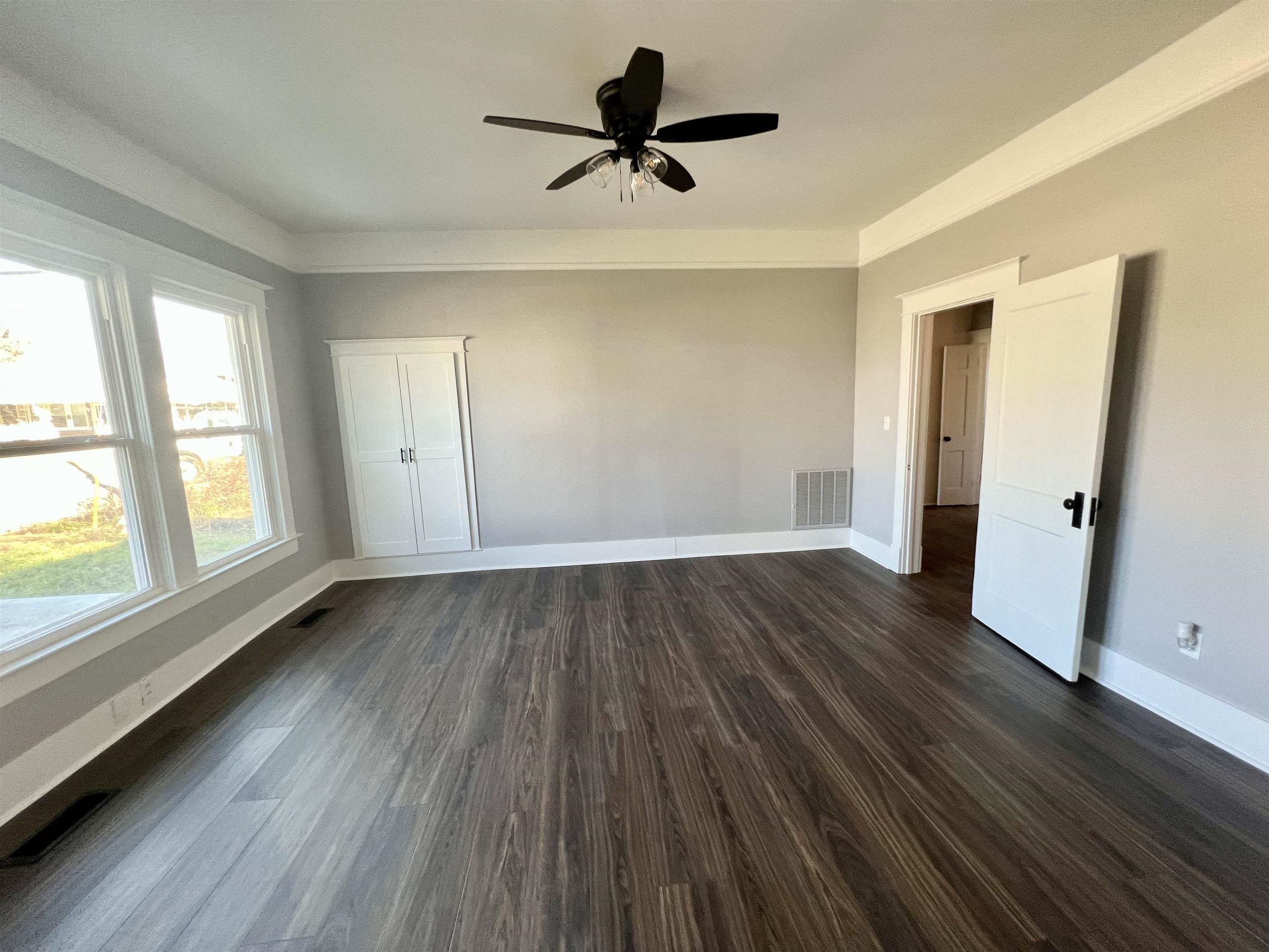 129 Wardlaw Circle Ripley, TN 38063 - Photo 7 of 24 an empty room with wooden floor and windows