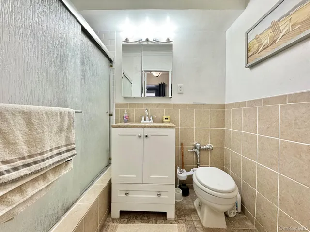 a bathroom with a toilet a sink and a mirror