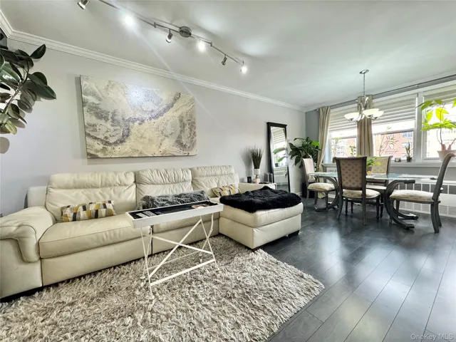 a living room with furniture and view of kitchen