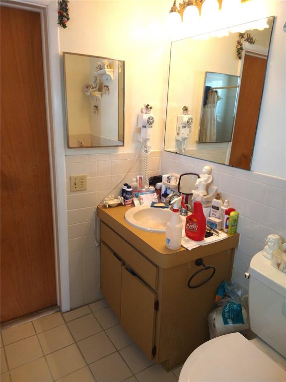 8415 Briarleaf Court Port Richey, FL 34668 - Photo 16 of 27 a bathroom with a sink mirror and toilet