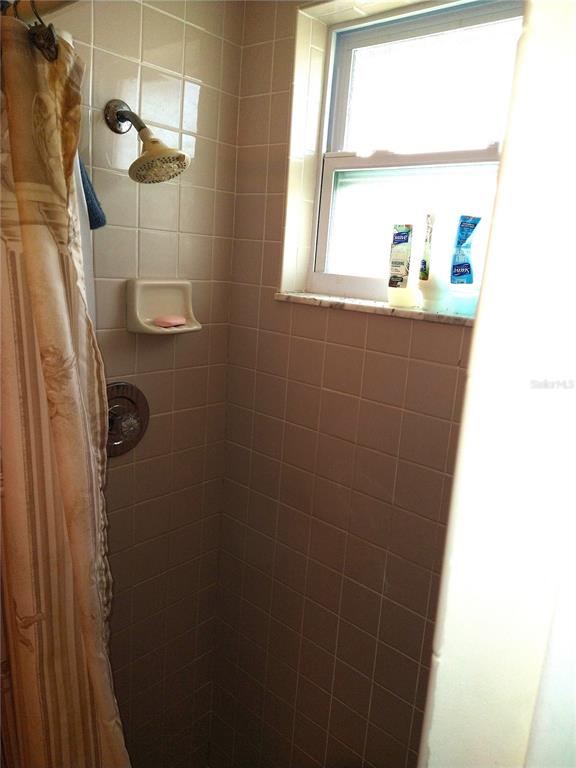 8415 Briarleaf Court Port Richey, FL 34668 - Photo 17 of 27 a bathroom with a shower and a window