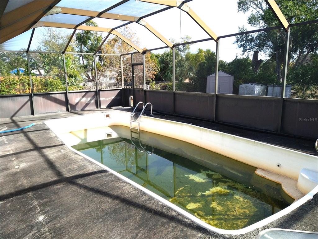 8415 Briarleaf Court Port Richey, FL 34668 - Photo 21 of 27 a view of a swimming pool with a patio