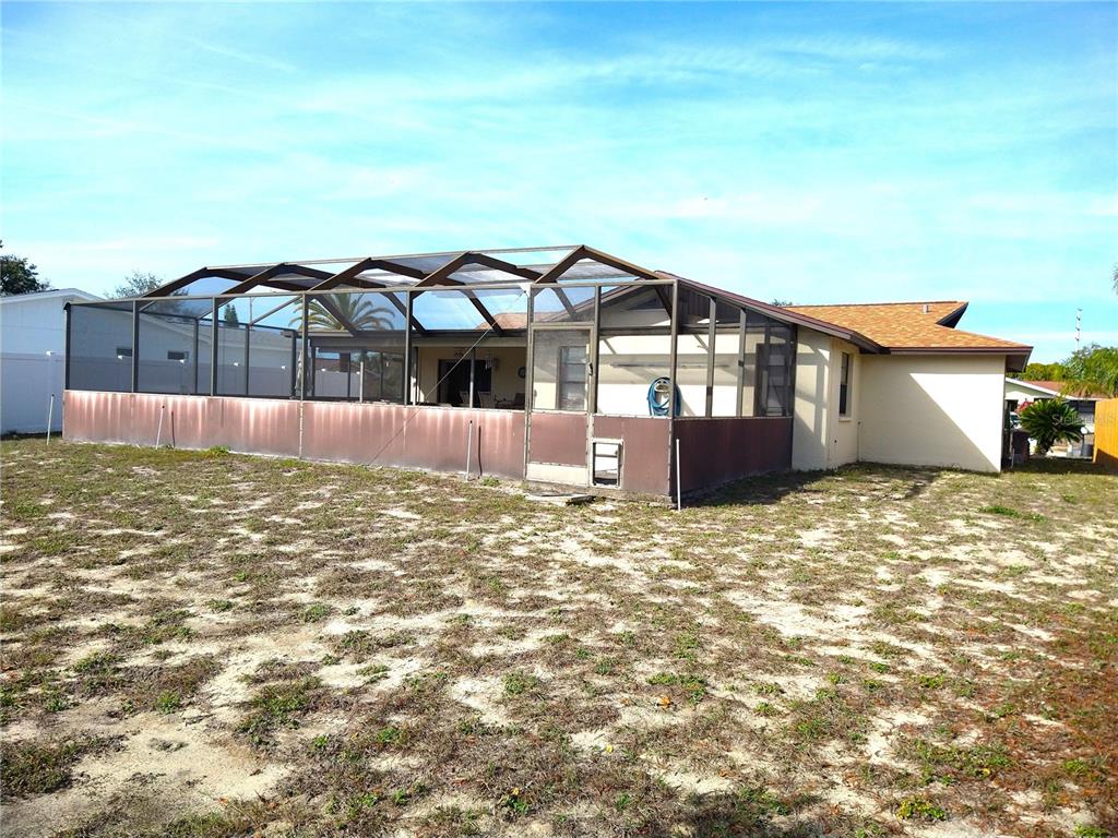 8415 Briarleaf Court Port Richey, FL 34668 - Photo 24 of 27 a view of a house with a yard