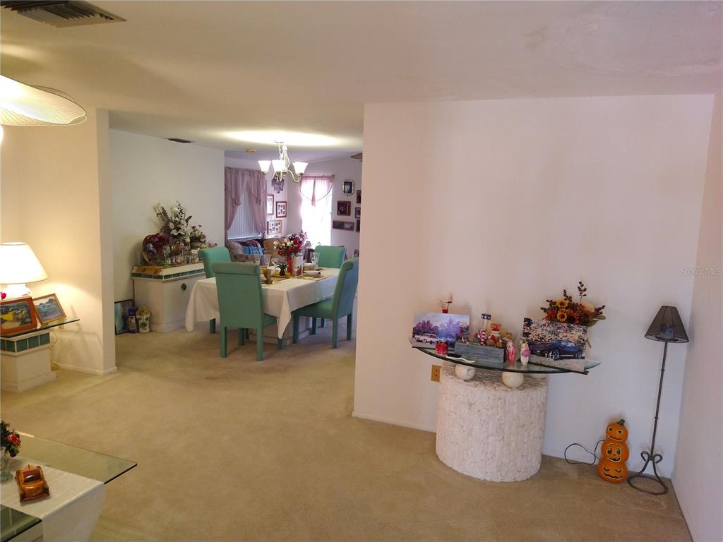 8415 Briarleaf Court Port Richey, FL 34668 - Photo 6 of 27 a room with a table and chairs