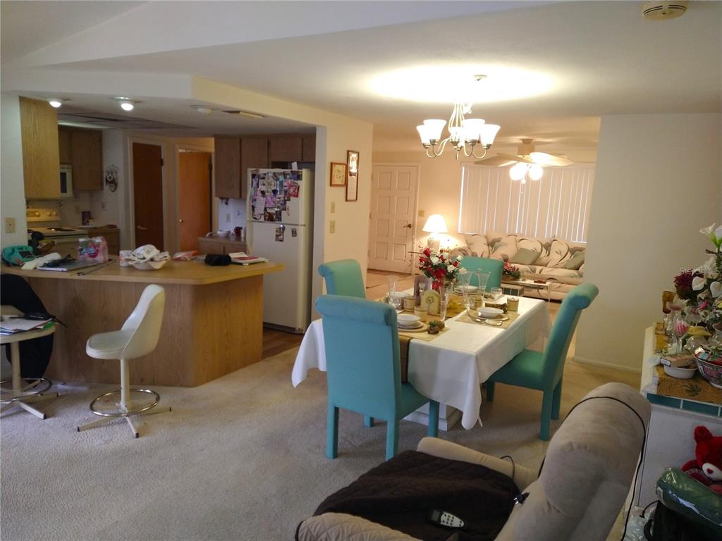 8415 Briarleaf Court Port Richey, FL 34668 - Photo 7 of 27 a view of a dining room with furniture and chandelier