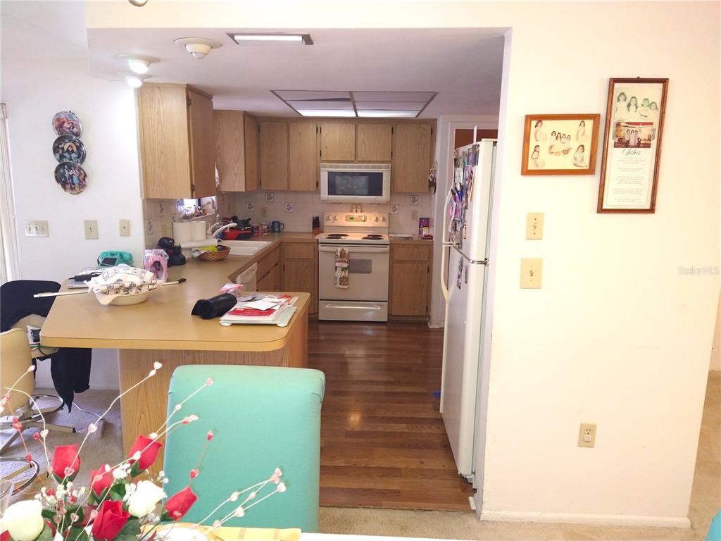 8415 Briarleaf Court Port Richey, FL 34668 - Photo 8 of 27 a kitchen that has a lot of white cabinets and stainless steel appliances