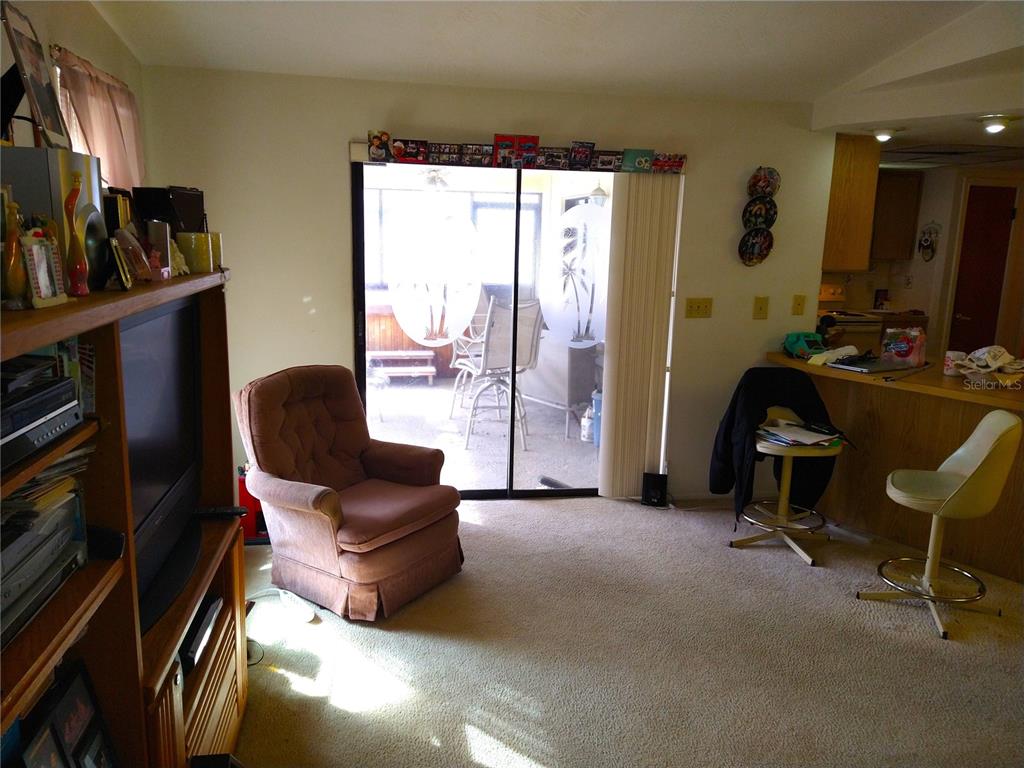 8415 Briarleaf Court Port Richey, FL 34668 - Photo 10 of 27 a living room with furniture and a flat screen tv