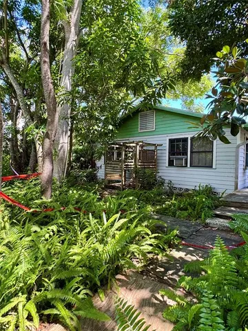 front view of a house with a tree