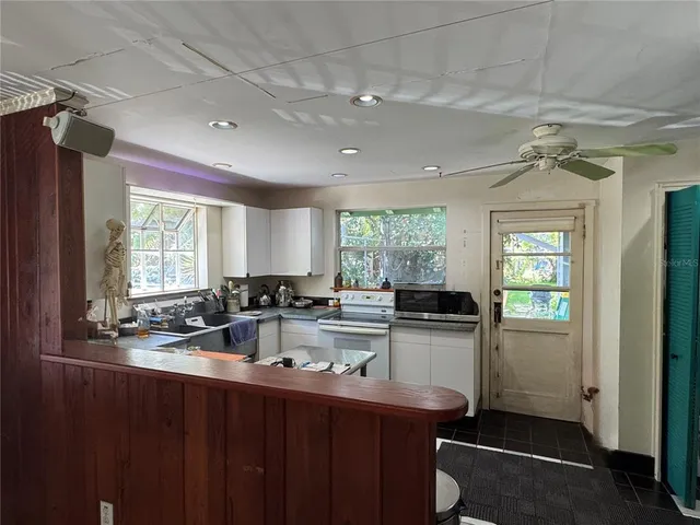 a kitchen with refrigerator and window