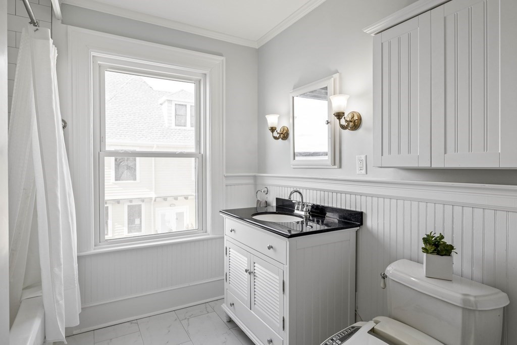 37 Lynn Shore Drive Lynn, MA 01902 - Photo 27 of 42 a bathroom with a granite countertop sink a toilet a window and mirror