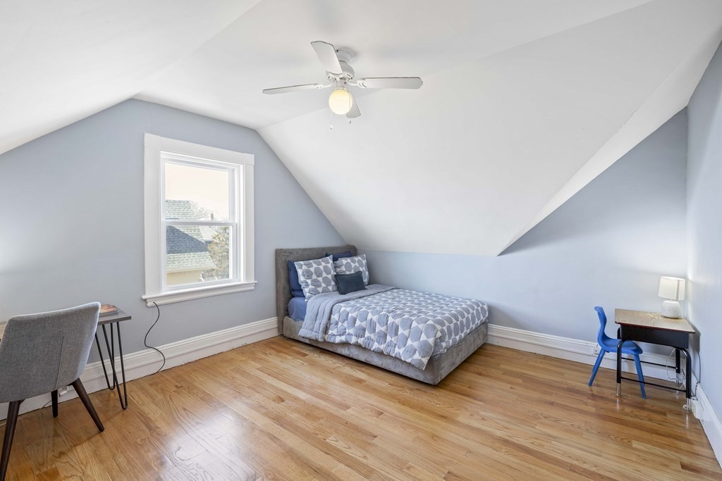 37 Lynn Shore Drive Lynn, MA 01902 - Photo 32 of 42 a bedroom with a bed and wooden floor