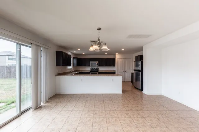 a view of a kitchen with a sink wooden floor and a kitchen view