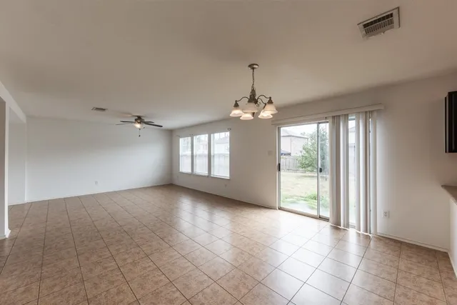 a view of a livingroom with a chandelier windows and chandelier