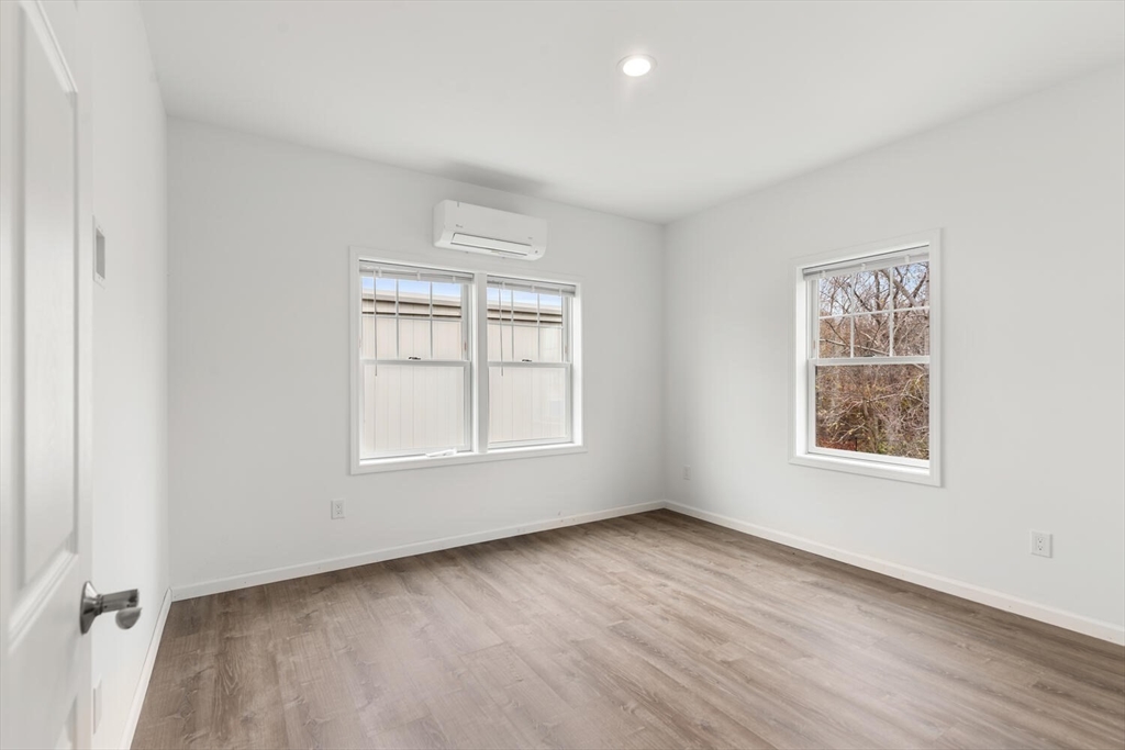 50 R Maplewood Avenue, Unit 215 Gloucester, MA 01930 - Photo 12 of 14 an empty room with wooden floor and windows