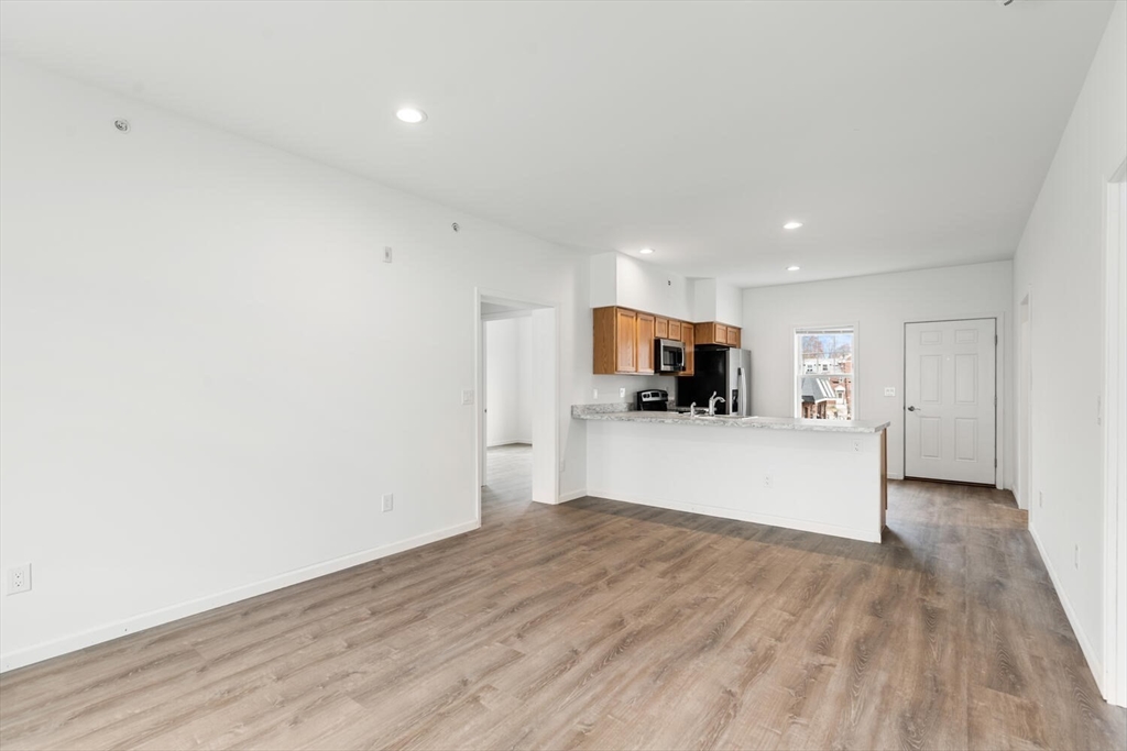 50 R Maplewood Avenue, Unit 215 Gloucester, MA 01930 - Photo 7 of 14 a view of kitchen with wooden floor