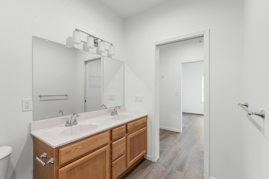 50 R Maplewood Avenue, Unit 215 Gloucester, MA 01930 - Photo 10 of 14 a bathroom with a sink a mirror and a toilet