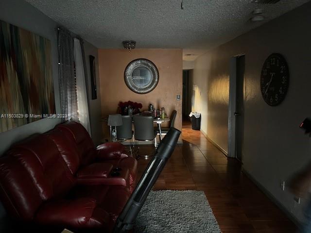 1755 Northwest 69th Street Miami, FL 33147 - Photo 12 of 36 a living room with furniture and a mirror