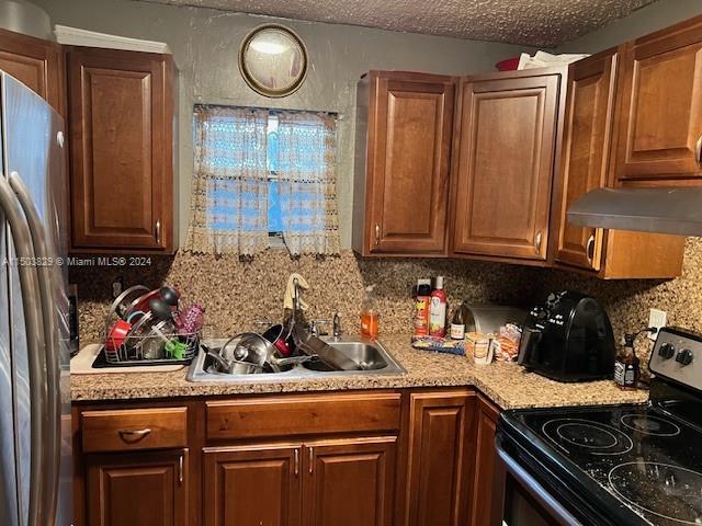 1755 Northwest 69th Street Miami, FL 33147 - Photo 13 of 36 a kitchen with stainless steel appliances granite countertop a stove a sink and a microwave