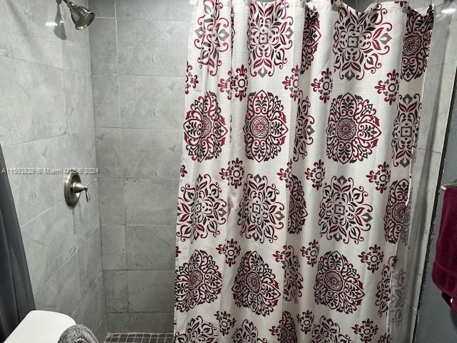 1755 Northwest 69th Street Miami, FL 33147 - Photo 15 of 36 a bathroom with a shower and toilet