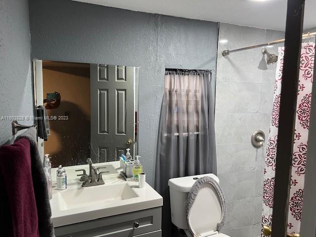 1755 Northwest 69th Street Miami, FL 33147 - Photo 16 of 36 a bathroom with a sink toilet and shower
