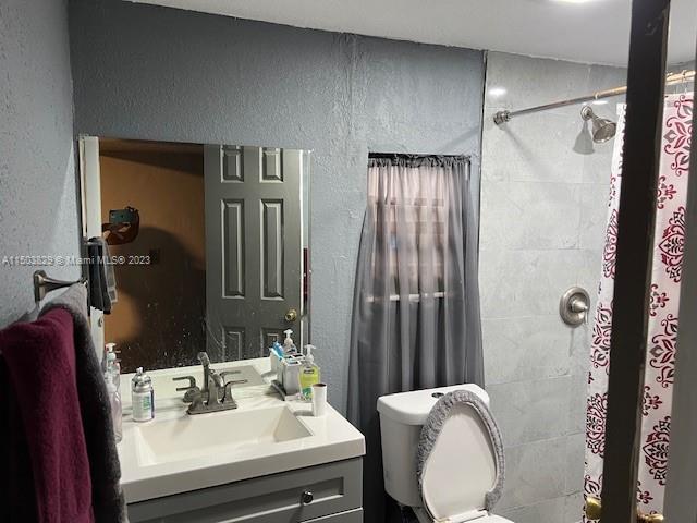 1755 Northwest 69th Street Miami, FL 33147 - Photo 17 of 36 a bathroom with a sink toilet and shower