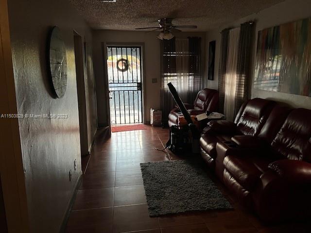 1755 Northwest 69th Street Miami, FL 33147 - Photo 26 of 36 a living room with furniture and a floor to ceiling window